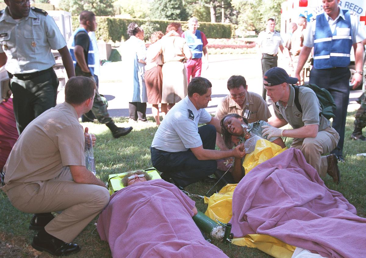 Rescue workers and Pentagon personnel attend to the wounded outside the Pentagon after a hijacked plane crashed into the building in Washington on Sept. 11, 2001. (Greg Whitesell/Getty Images)