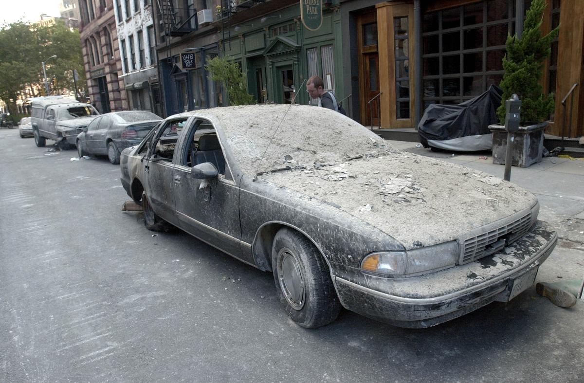 The remains of a charred car lie on the side of the road in New York City on Sept. 12, 2001. A terrorist attack on the World Trade Center left the twin towers in rubble, killing thousands. (Darren McCollester/Getty Images)