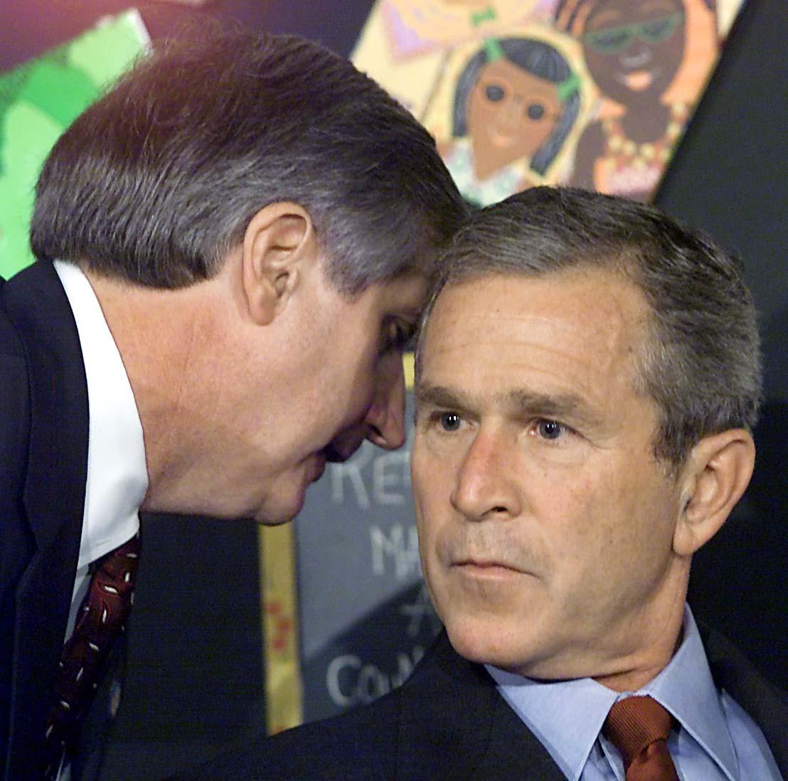 President George W. Bush (R) being informed by his chief of staff Andrew Card of the attacks on the World Trade Center in New York during an early morning school reading event in Sarasota, Florida, on Sept. 11, 2001. (Paul J. Richards/AFP/Getty Images)