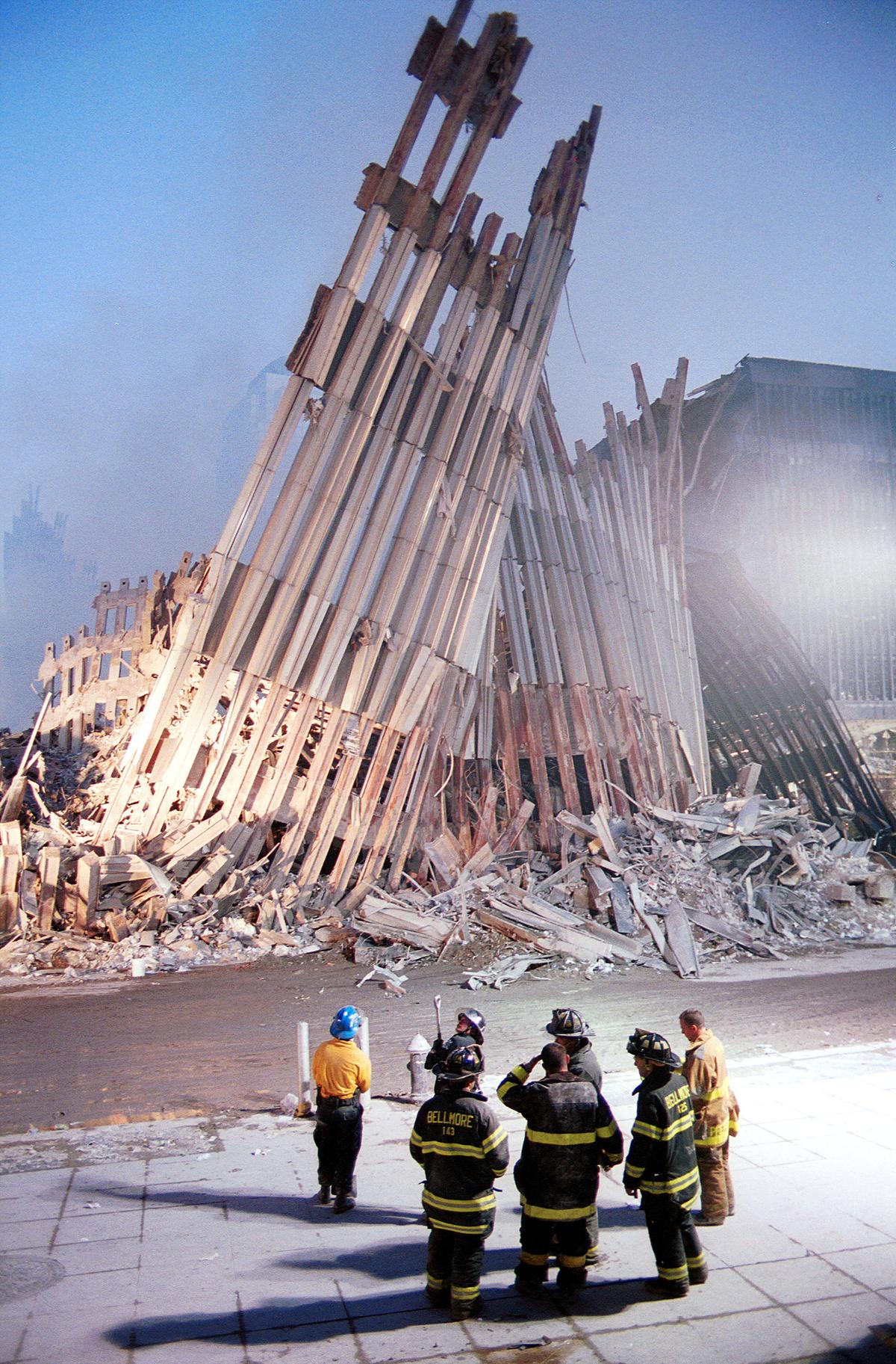 New York City firefighters look at the destroyed facade of the World Trade Center Sept. 13, 2001, two days after the twin towers were destroyed when hit by two hijacked passenger jets in a terrorist attack. (Chris Hondros/Getty Images)