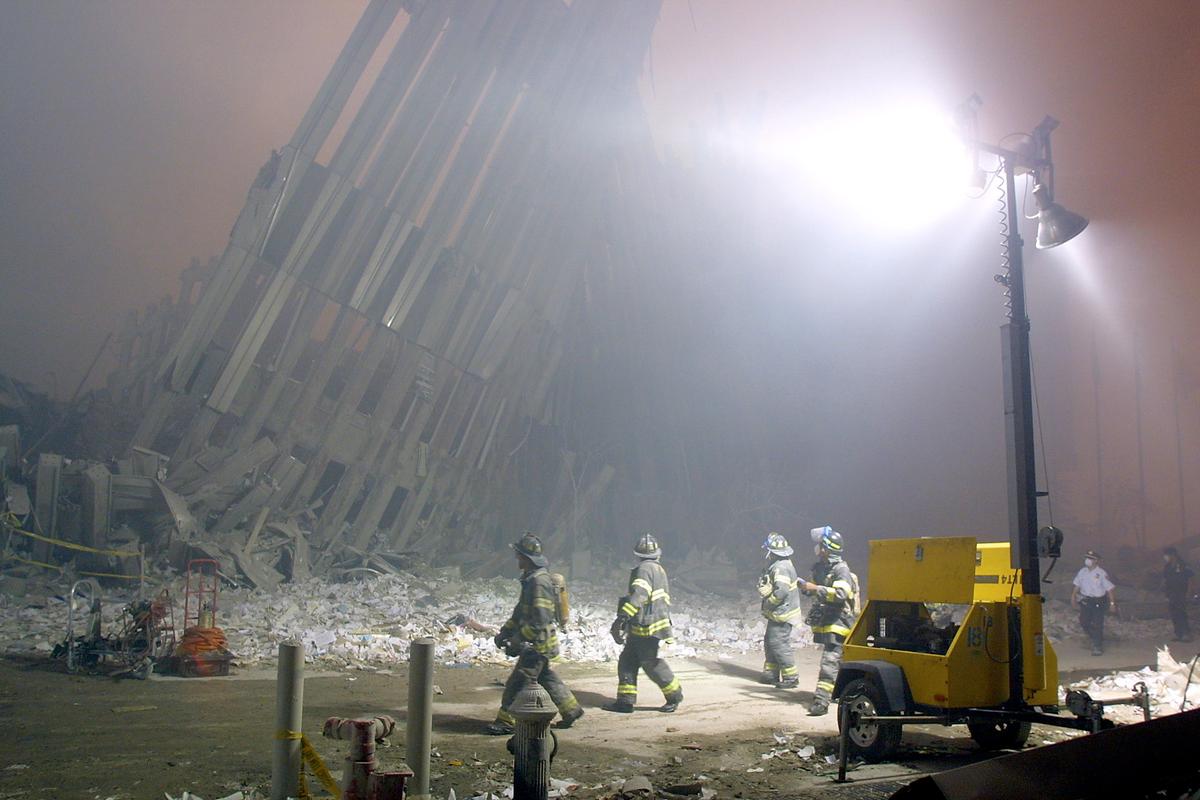 Firefighters make their way through the rubble of the World Trade Center in New York after two hijacked planes flew into the landmark skyscrapers on Sept. 11, 2001. (Doug Kanter/AFP/Getty Images)