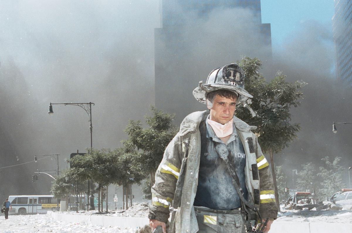 An unidentified New York City firefighter walks away from Ground Zero after the collapse of the Twin Towers in New York City on Sept. 11, 2001. The World Trade Center's Twin Towers and the Pentagon were attacked by terrorists using commercial airliners as missiles. (Anthony Correia/Getty Images)