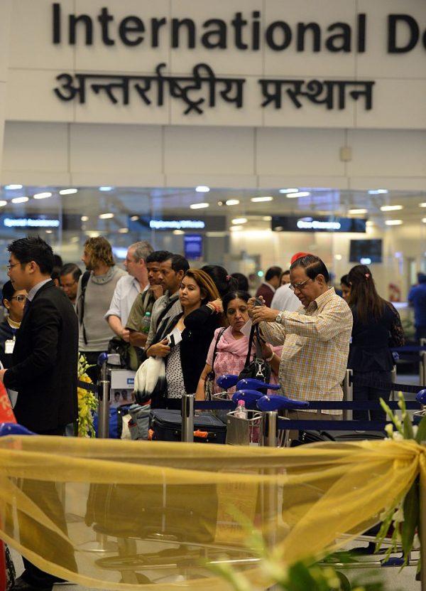 Passengers wait in line to check-in at the departure hall at Terminal 3 of Indira Gandhi International airport in New Delhi, India, on Nov. 5, 2014. (Prakash Singh/AFP/Getty Images)