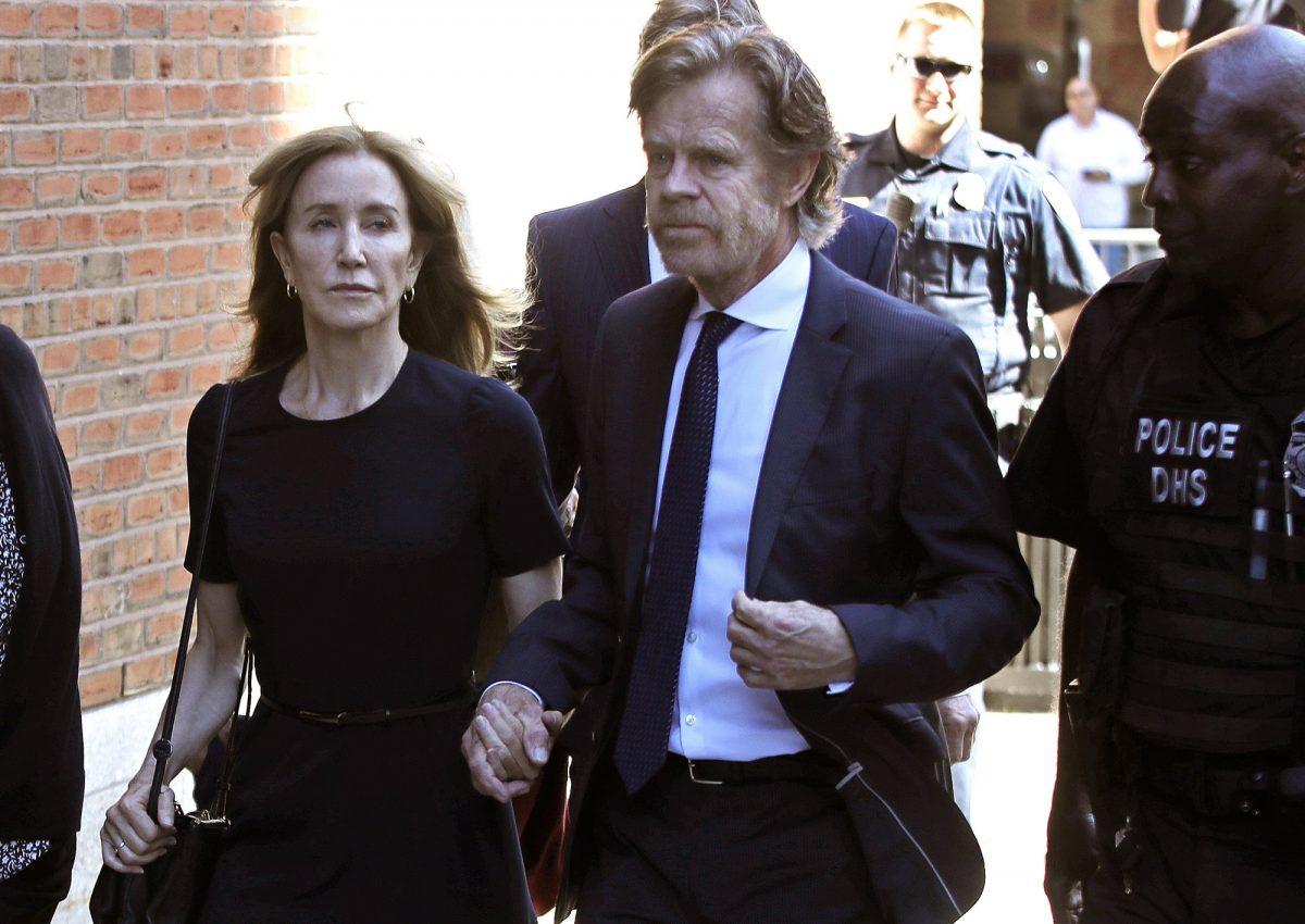 Felicity Huffman arrives at federal court with her husband William H. Macy for sentencing in a nationwide college admissions bribery scandal in Boston on Sept. 13, 2019. (AP Photo/Elise Amendola)