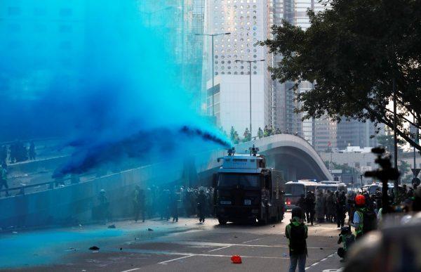 Police vehicle sprays blue-coloured water towards anti-government protesters during a demonstration near Central Government Complex in Hong Kong, on Sept. 15, 2019. (Jorge Silva/Reuters)