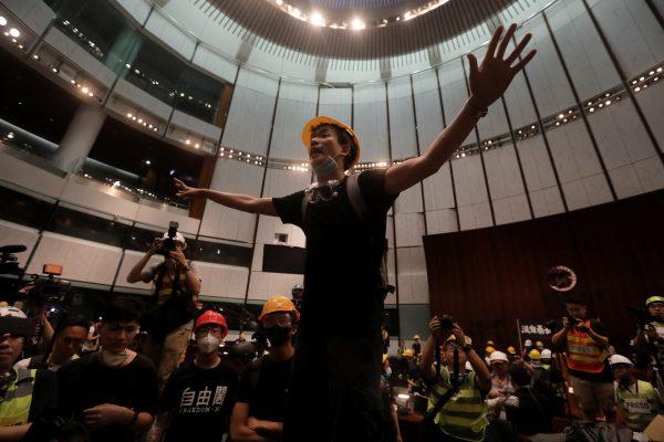 Brian Leung Kai-ping gestures after protesters broke into the parliament chamber of the government headquarters in Hong Kong on July 1, 2019, on the 22nd anniversary of the city's handover from Britain to China. (Vivek Prakash/AFP/Getty Images)