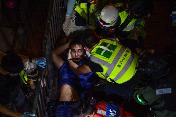 An injured man is being taken care of by first aid rescuers during a protest outside North Point metro station in Hong Kong on Sept. 15, 2019. (Nicolas Asfouri/AFP/Getty Images)