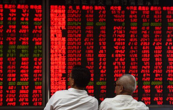 Investors monitor stock price movements at a securities company in Beijing on June 15, 2016. (Greg Baker/AFP/Getty Images)