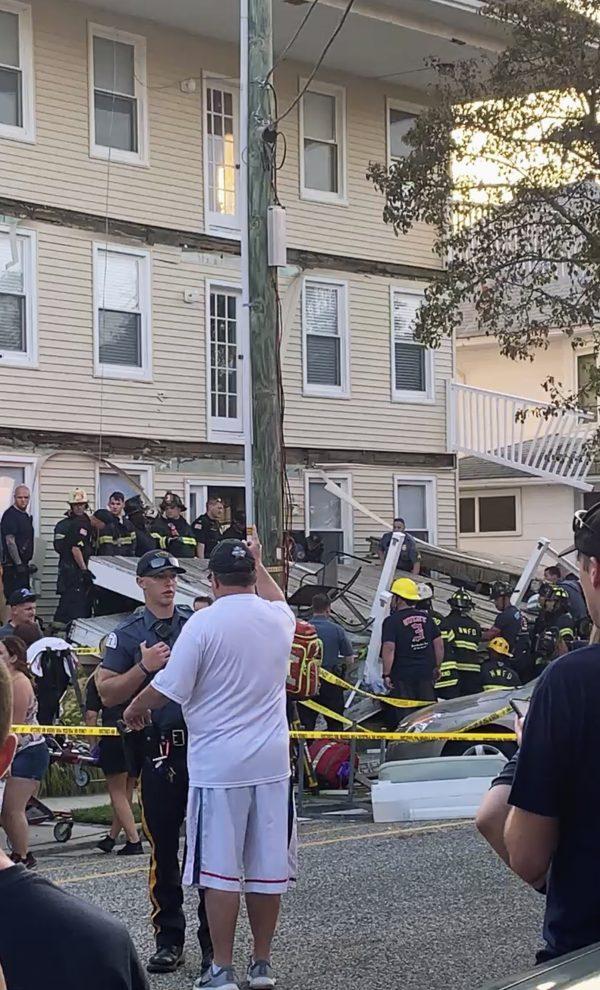 First responders work the scene of a building structure damage, in the background, in Wildwood, N.J., on Sept. 14, 2019. (James Macheda via AP)