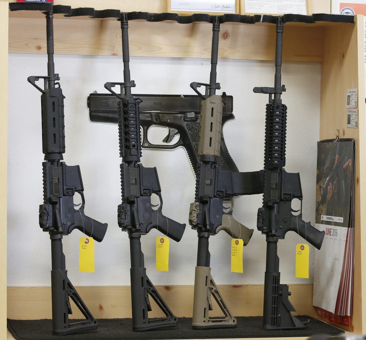AR-15 semi-automatic guns are on display for sale at a gun store in a 2016 file photograph. (Photo by George Frey/Getty Images)