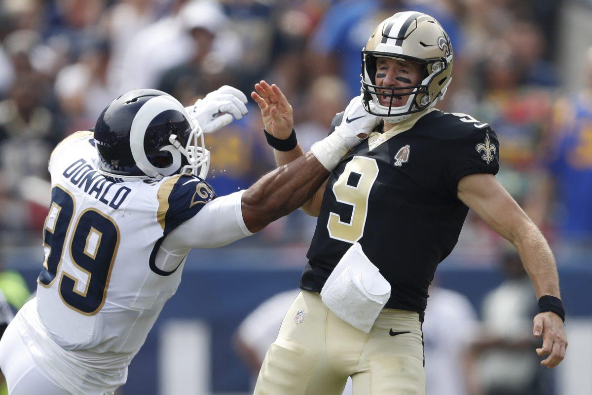 Drew Brees #9 of the New Orleans Saints injures his throwing hand as he is hit by Aaron Donald #99 of the Los Angeles Rams during the first quarter in the game at Los Angeles Memorial Coliseum in Los Angeles on Sept. 15, 2019. (Sean M. Haffey/Getty Images)