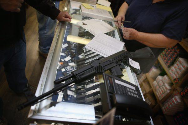 In this file image, a customer purchases an AK-47 style rifle for about $1200 at an Illinois store on Dec. 17, 2012. (Scott Olson/Getty Images)