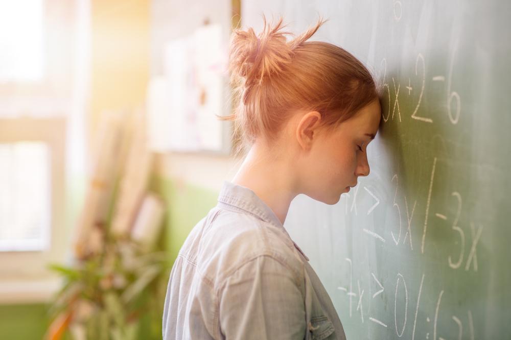 Illustration - Shutterstock | <a href="https://www.shutterstock.com/image-photo/teenager-girl-math-class-overwhelmed-by-1054012055">ABO PHOTOGRAPHY</a>