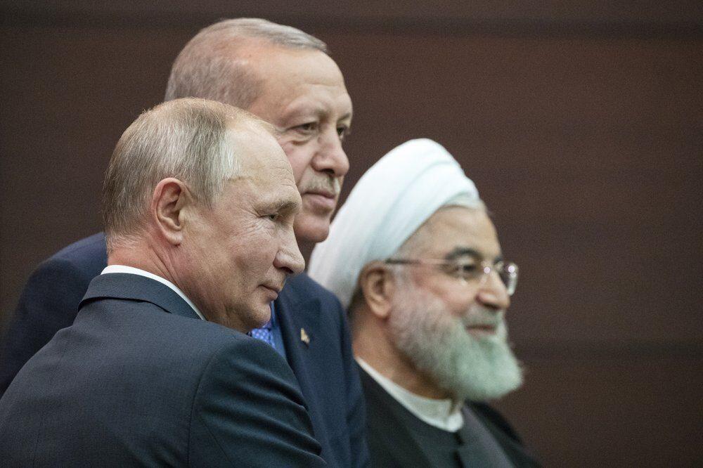 Russian President Vladimir Putin (L), Turkish President Recep Tayyip Erdogan and Iranian President Hassan Rouhani (R) pose for a picture after a news conference during their meeting in Ankara, Turkey, on Sept. 16, 2019. (Pavel Golovkin/AP Photo)