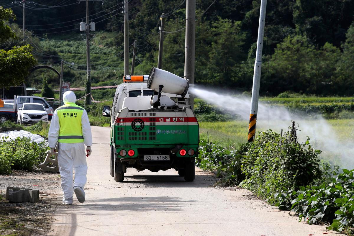 A vehicle sprays disinfectant solution as a precaution against African swine fever at a pig farm in Paju, South Korea on Sept. 17, 2019. (Lim Byung-shick/Yonhap via AP)