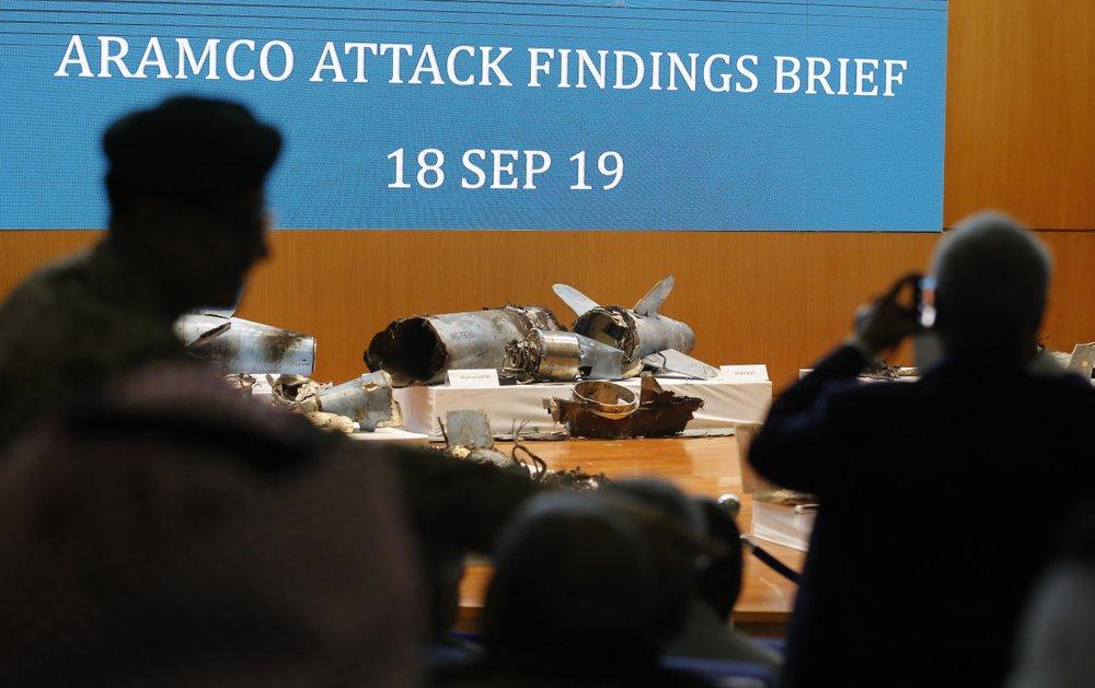 Journalists film what Saudi military spokesman Col. Turki al-Malki said was evidence of Iranian weaponry used in the attack targeted Saudi Aramco's facilities in Abqaiq and Khurais, during a press conference in Riyadh, Saudi Arabia, on Sept. 18, 2019. (Amr Nabil/AP Photo)