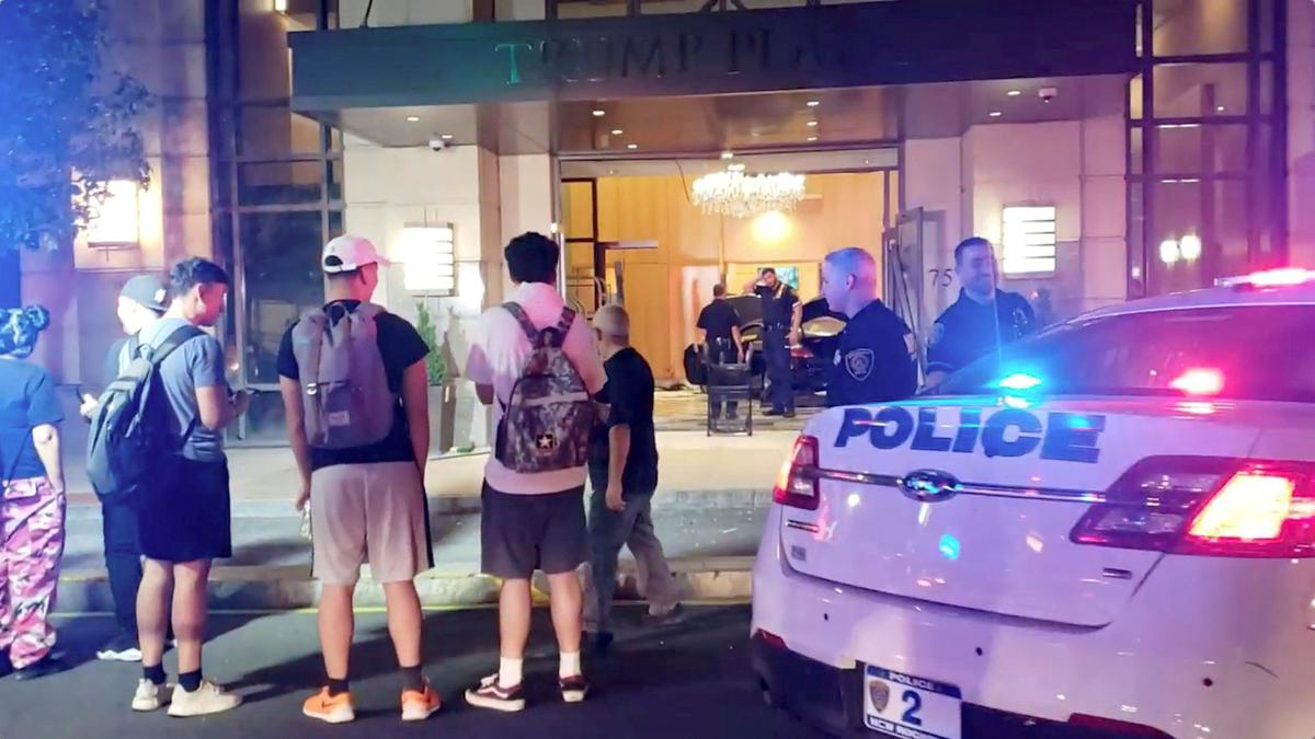 People and police officers stand outside Trump Plaza after a car crashed into the building's lobby in New Rochelle, New York, U.S., Sept. 17, 2019. (Jose Abarca via Reuters)