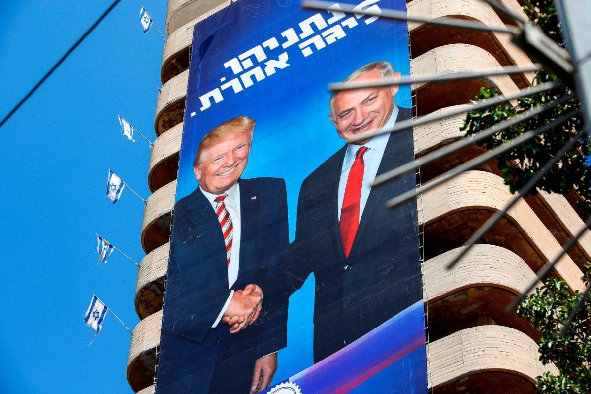 Two giant Israeli Likud Party election banners hanging from a building showing Israeli Prime Minister Benjamin Netanyahu shaking hands with US President Donald Trump, with a caption above reading in Hebrew "Netanyahu, in another league", in the coastal Mediterranean city of Tel Aviv, on July 28, 2019. (JACK GUEZ/AFP/Getty Images)