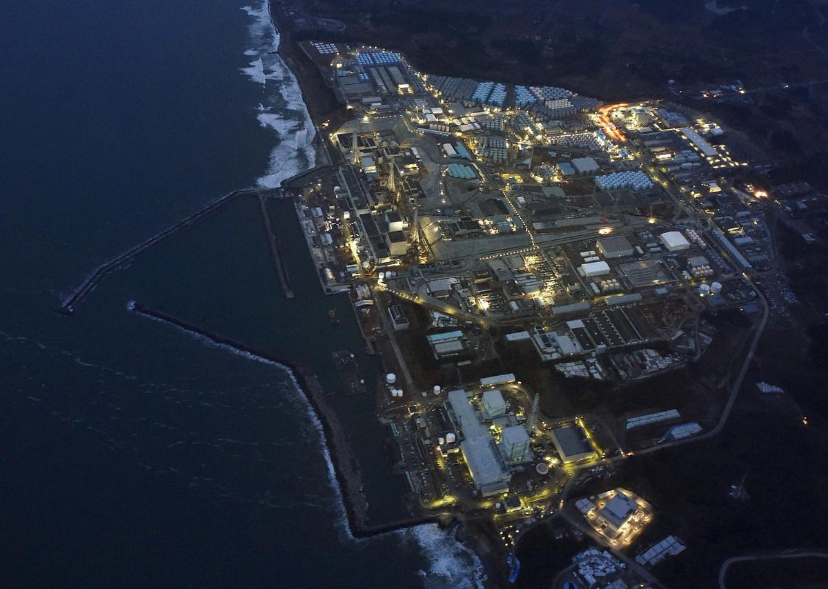 Tokyo Electric Power Co.'s (TEPCO) tsunami-crippled Fukushima Daiichi nuclear power plant is illuminated for decommissioning operation in the dusk in Okuma town, Fukushima prefecture, Japan, in this aerial view photo taken by Kyodo on March 10, 2016. (Kyodo/File Photo via Reuters)