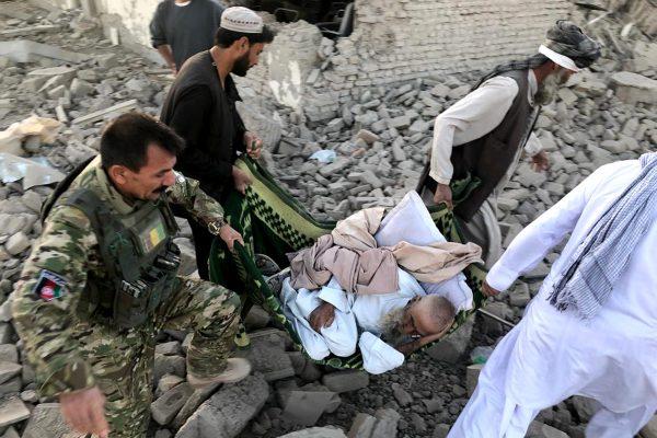 An Afghan security member and people carry an injured man after a suicide attack in Zabul, Afghanistan on Sept. 19, 2019. (Ahmad Wali Sarhadi/AP Photo)