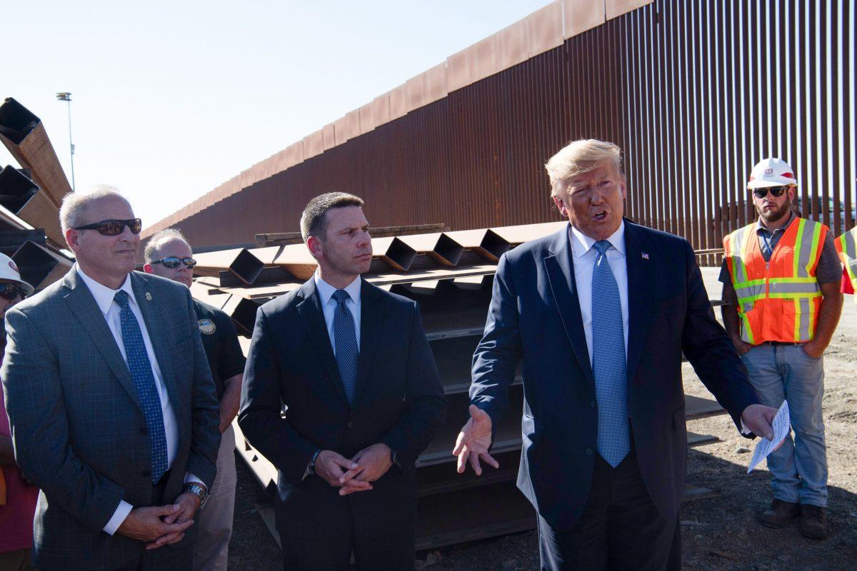 President Donald Trump, second from right, speaks to reporters during a visit to the United States–Mexico border wall on Sept. 18, 2019. Customs and Border Protection Commissioner Mark Morgan (L) and Department of Homeland Security Acting Secretary Kevin McAleenan (2nd L) listen. (Nicholas Kamm/AFP/Getty Images)