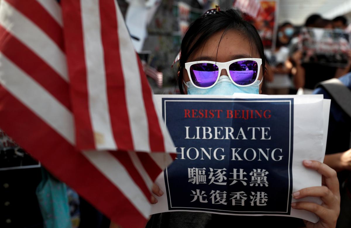 An anti-government protester holds a placard during a rally at the University of Hong Kong, China on Sept. 20, 2019. (Jorge Silva/Reuters)