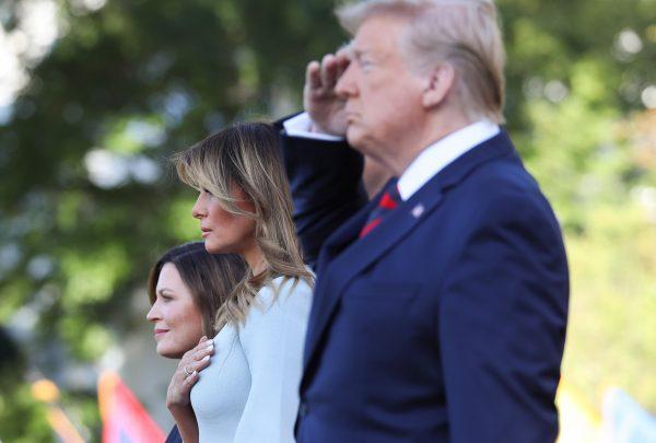 U.S. President Donald Trump and First Lady Melania Trump stand at attention with Australian Prime Minister Scott Morrison (unseen) and his wife Jenny Morrison (L) during an Official Visit by the Australian PM at the White House in Washington, DC on Sept. 20, 2019. (Photo by Alex Edelman/AFP/Getty Images)