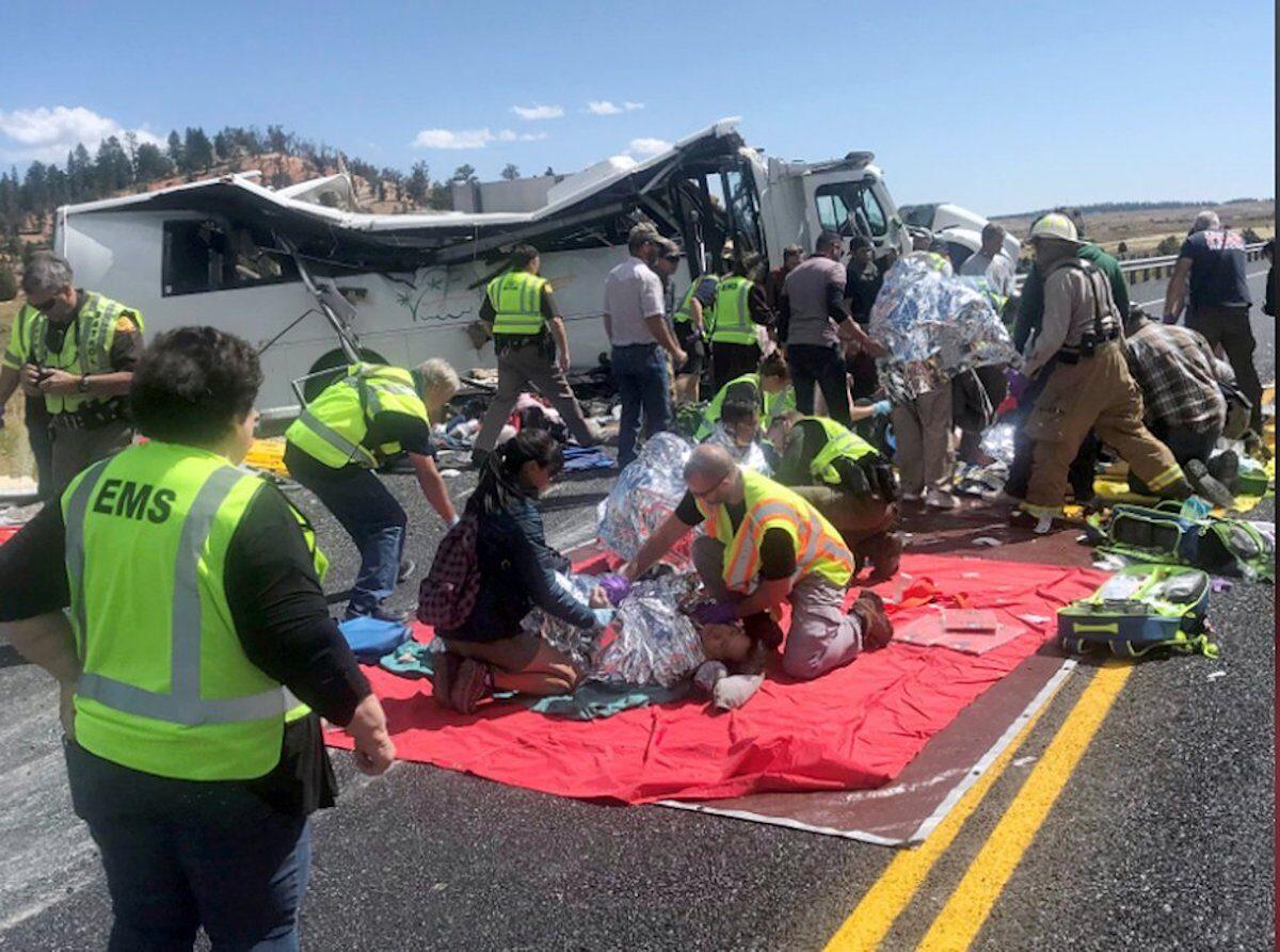 In this photo released by the Garfield County Sheriff’s Office, Emergency Medical Services personnel assist victims of a bus crash near Bryce Canyon National Park in southern Utah, on Sept. 20, 2019. (Sheriff Danny Perkins/Garfield County Sheriff’s Office via AP)