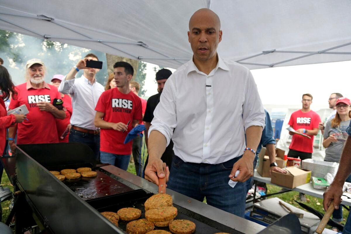 Democratic presidential candidate Sen. Cory Booker (D-N.J.) flips veggie burgers at the Polk County Democrats Steak Fry, in Des Moines, Iowa on Sept. 21, 2019. He's among the Democratic presidential candidates who support confiscating guns. (Nati Harnik/AP Photo)