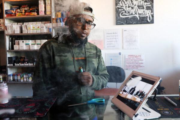 Andy Ramkumar, who works at Gotham Vape in Queens, vapes at the store in New York City on Sept. 17, 2019. (Spencer Platt/Getty Images)