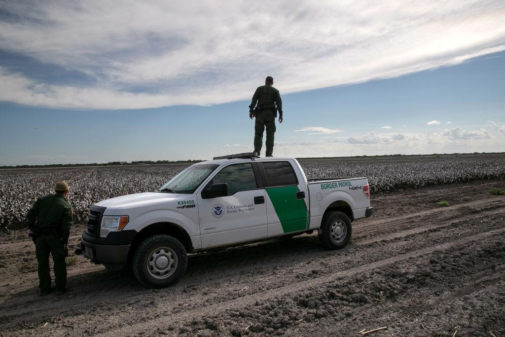An active-duty U.S. Army soldier scans for undocumented immigrants in a cotton field near the U.S.-Mexico border fence in Penitas, Texas, on Sept. 10, 2019. (John Moore/Getty Images)
