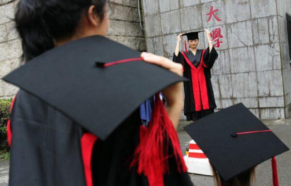 Graduates pose for pictures during a graduation ceremony at Renmin University in Beijing on June 29, 2006. (China Photos/Getty Images)