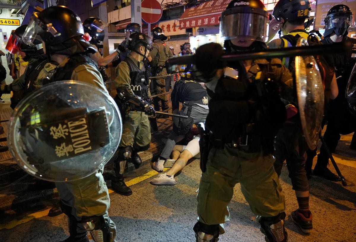 Police officers detain an anti-government protester during a rally outside Mong Kok Police Station, in Hong Kong on Sept. 22, 2019. (Aly Song/Reuters)