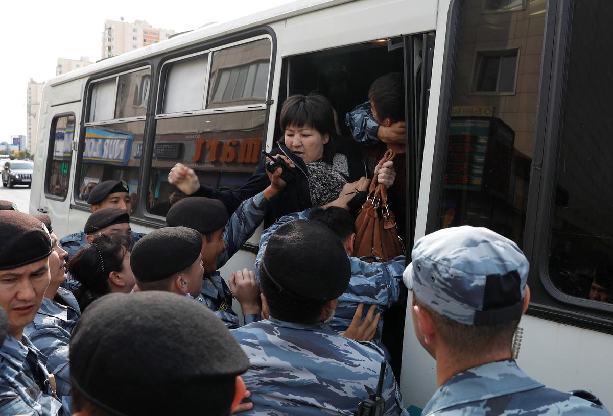 Kazakh law enforcement officers detain a woman during a rally held by opposition supporters in Nur-Sultan, Kazakhstan on Sept. 21, 2019. (Mukhtar Kholdorbekov/Reuters)