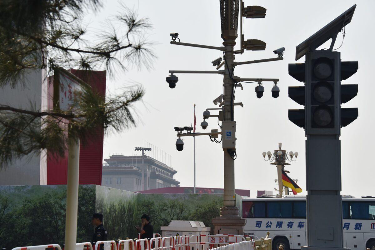  Security guards patrol below surveillance cameras on a corner of Tiananmen Square in Beijing, China, on Sept. 6, 2019. (Greg Baker/AFP/Getty Images)