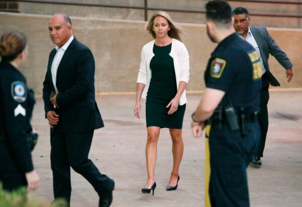 Former Dallas police officer Amber Guyger is escorted by a security detail as she arrives for her murder trial at the Frank Crowley Courthouse in downtown Dallas on Sept. 24, 2019. (LM Otero/AP Photo)