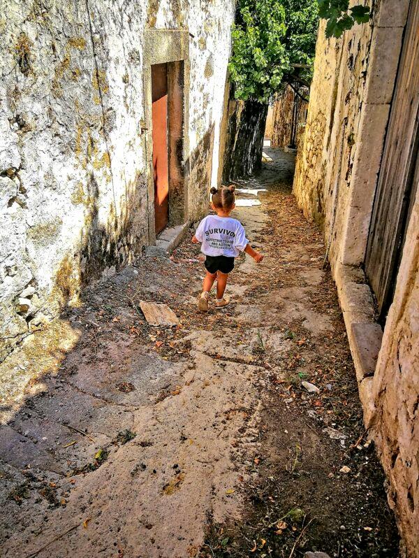 Little Anna Maria passing the way her father’s father passed through ancient Ano Asites. (Phil Butler)
