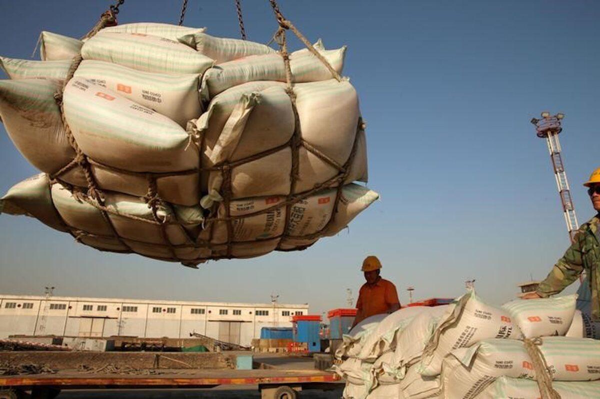 Workers transport imported soybean products at a port in Nantong, Jiangsu Province, China, on April 9, 2018. (Reuters)