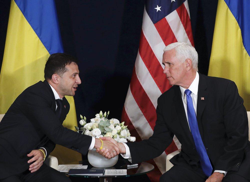 In this file photo taken on Sept. 1, 2019, Ukraine's President Volodymyr Zelenskiy, left, shakes hands with U.S. Vice President Mike Pence, in Warsaw, Poland. (AP Photo/Petr David Josek, File)
