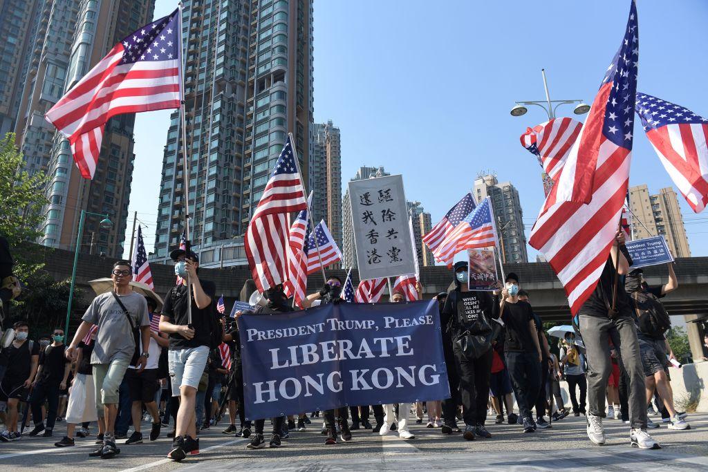 Protesters with U.S. national flags take part in a pro-democracy march in Hong Kong's Tuen Mun district on Sept. 21, 2019. (Nicolas Asfouri/AFP/Getty Images)