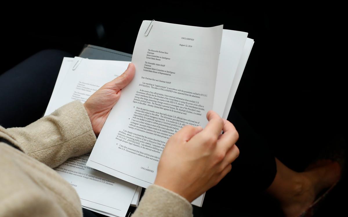 A member of the audience holds a copy of the whistleblower complaint letter sent to Senate and House Intelligence Committees during testimony by Acting Director of National Intelligence Joseph Maguire before the House Intelligence Committee on Capitol Hill in Washington on Sept. 26, 2019. (Pablo Martinez Monsivais/AP Photo)