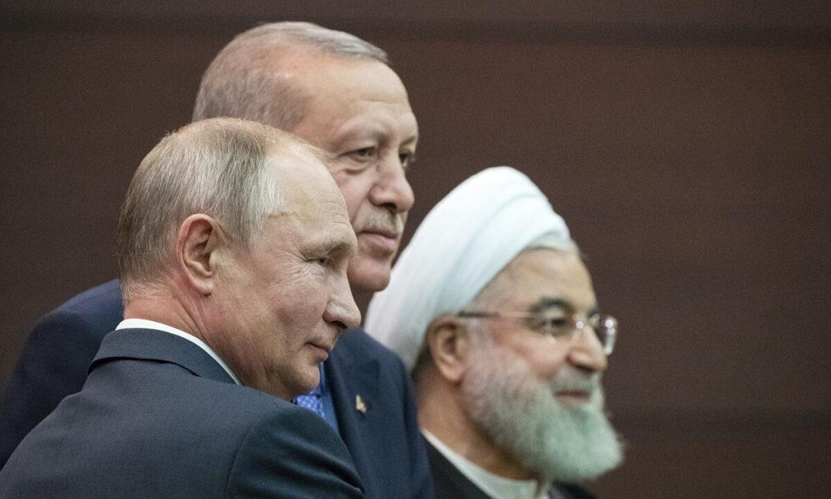 Russian President Vladimir Putin (L), Turkish President Recep Tayyip Erdogan and Iranian President Hassan Rouhani (R) pose for a picture after a news conference during their meeting in Ankara, Turkey, on Sept. 16, 2019. (Pavel Golovkin/AP Photo)
