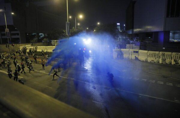 Police fire blue-colored water on protestors in Hong Kong, on Sept. 28, 2019. (AP Photo/Kin Cheung)