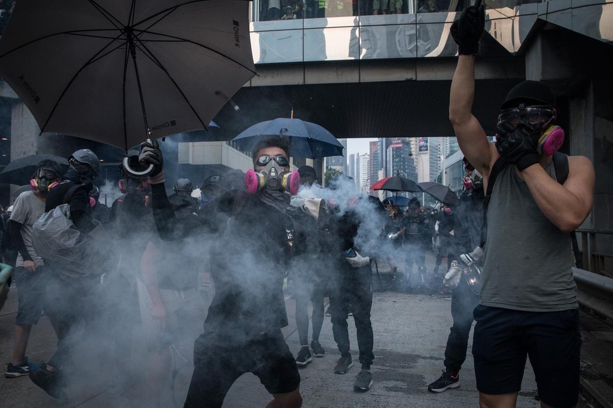 A pro-democracy protester throws a tear gas canister back at police amid clashes during a march in Hong Kong on Sept. 29, 2019. (Chris McGrath/Getty Images)