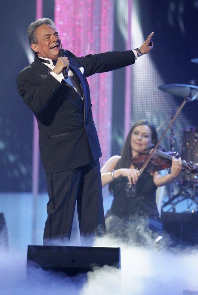 In this April 28, 2011 file photo, Jose Jose performs during the Latin Billboard Awards, in Coral Gables, Fla. Local media outlets report that the Mexican crooner died Saturday, Sept. 28, 2019, from pancreatic cancer. He was 71. (AP Photo/Carlo Allegri, File)