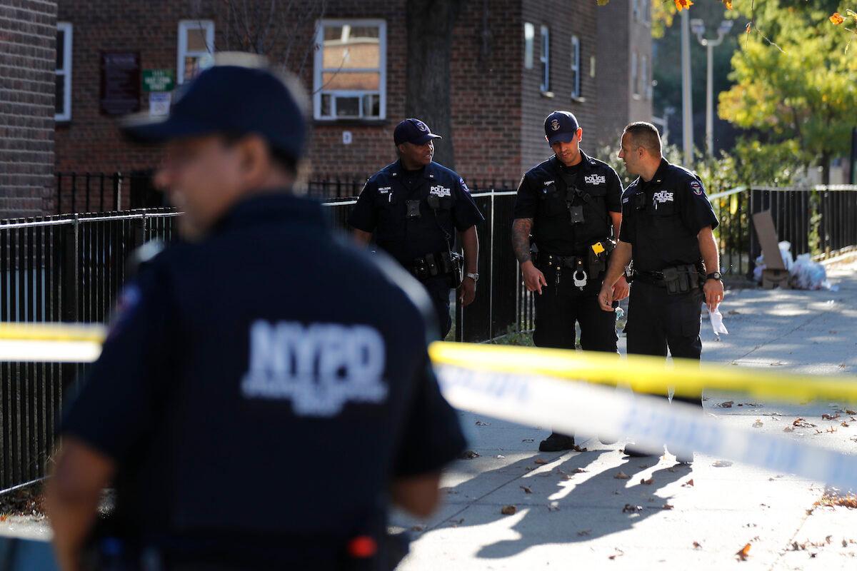 Emergency personnel work near the scene of a fatal shooting of a police officer in the Bronx borough of New York City on Sept. 29, 2019. (Seth Wenig/AP Photo)