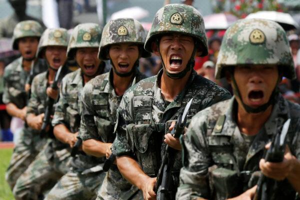 People's Liberation Army (PLA) soldiers take part in a performance during an open day at Stonecutters Island naval base in Hong Kong, on June 30, 2019. (Tyrone Siu/Reuters)
