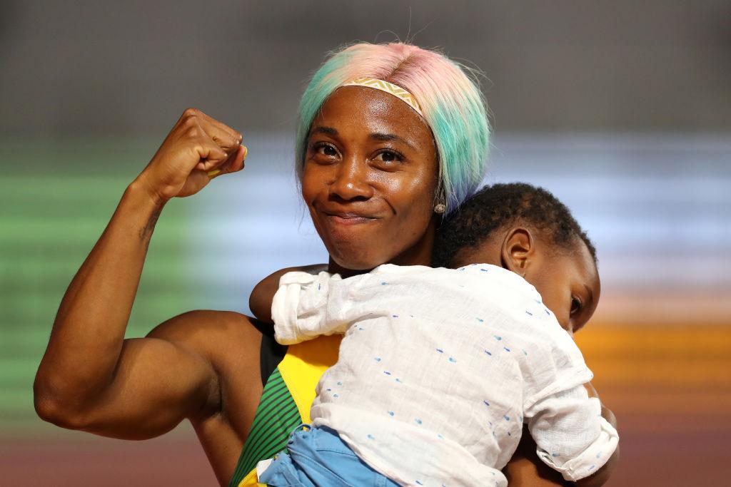 Fraser-Pryce celebrates by taking her baby son Zyon on a victory lap after winning the Women's 100 Meters. (©Getty Images | <a href="https://www.gettyimages.com.au/detail/news-photo/shelly-ann-fraser-pryce-of-jamaica-celebrates-with-her-son-news-photo/1177920296">Richard Heathcote</a>)