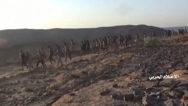 Alleged members of coalition forces walk after being captured by Houthi forces during an attack near the border with Saudi Arabia's southern region of Najran in Yemen, in this still image taken from video on Sept. 29, 2019. Houthi military officials claim that offensive defeated "enemy forces" leading to capture of Saudi soldiers, officers and vehicles. (Al Masirah/Houthi Military Media Center/Reuters TV via REUTERS)