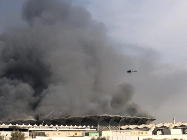 A firefighting helicopter sprays water on a fire at the Haramain high-speed rail station in Jeddah, Saudi Arabia, on Sept. 29, 2019. (Ismail Nofal/Reuters)